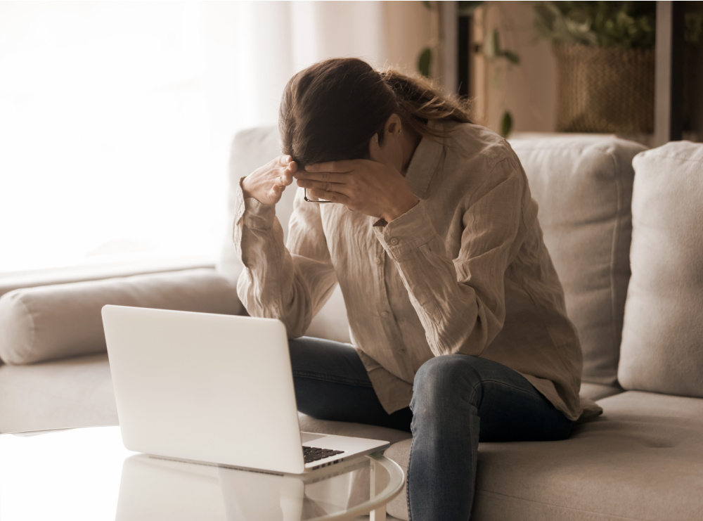 frustrated woman sitting at laptop figuring out how to build website