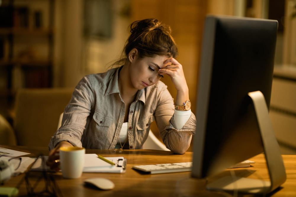 frustrated woman working on laptop